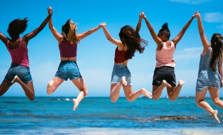 girls jumping together