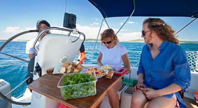 women preparing meal on boat